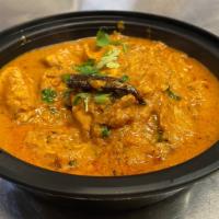 Fish Madras · Haddock cooked in hot and tangy madras sauce, ginger, fresh herbs and coconut. Served with b...