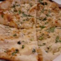 Garlic Naan · One piece. Leavened handmade white made with garlic, herbs and Indian spices. Served hot fro...