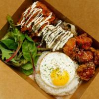 Kongbination (Rice Box) · Combination of (bulgogi spicy pork, sweet and sour chicken) seasoned rice with a fried egg o...