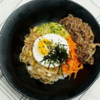 Bibimbap · Bowl of rice topped with vegetables.