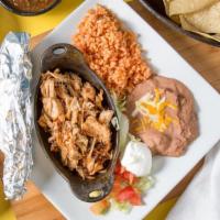 Carnitas · Pulled pork, lettuce, tomato, cheese, sour cream, tortillas (served with refried beans and r...