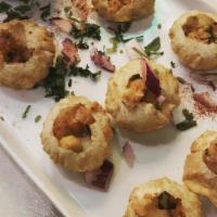 Pani Puri · Six puffed flour bowls stuffed with potatoes, chickpeas, tangy spices and tamarind water.