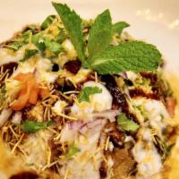 Mint Raj Kachori · A large puffed pastry stuffed with green sprouts, diced potatoes and chickpeas topped with t...