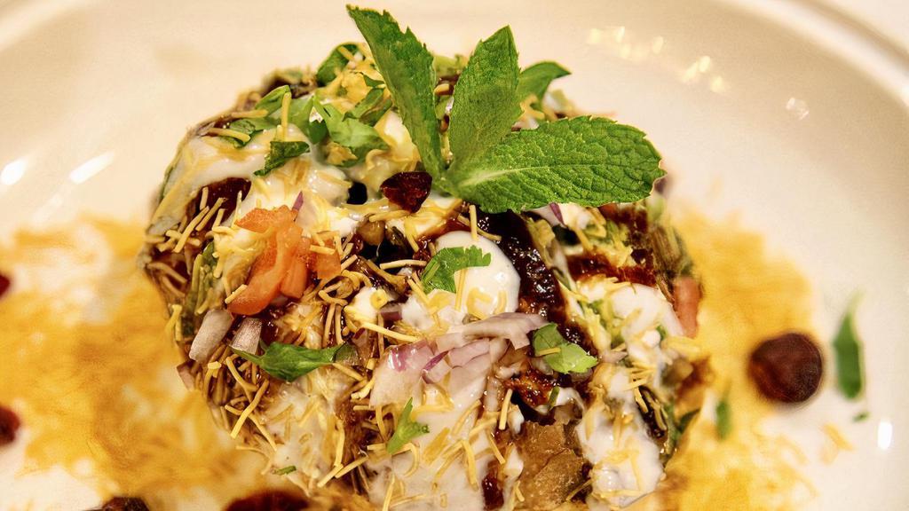 Mint Raj Kachori · A large puffed pastry stuffed with green sprouts, diced potatoes and chickpeas topped with tangy Indian chutneys.