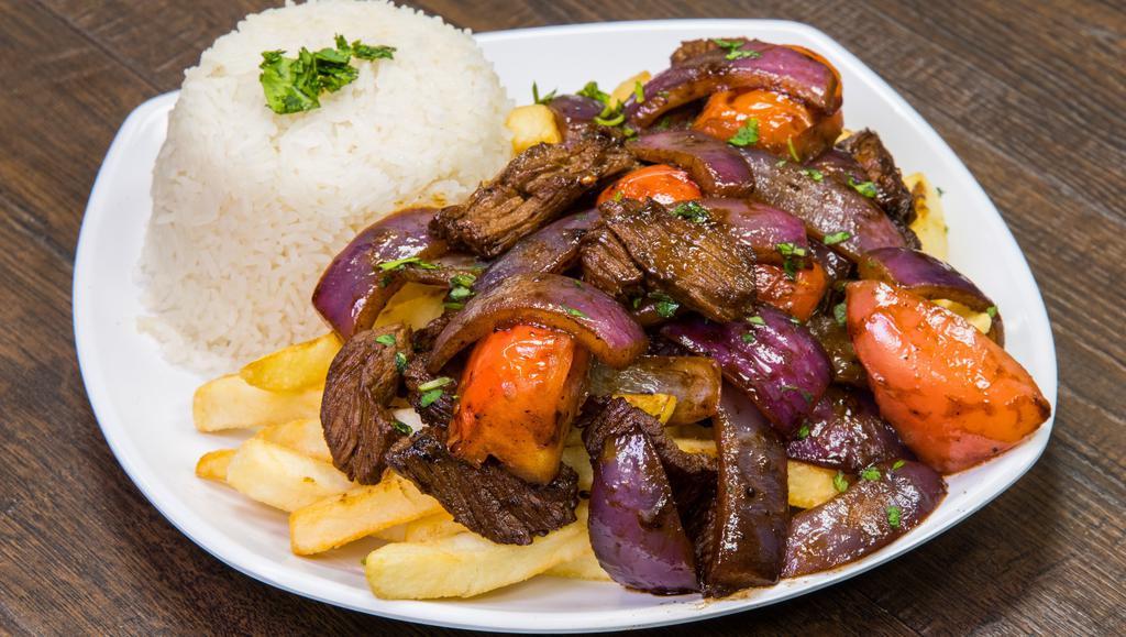 Lomo Saltado · tender steak with onions, tomatoes, cilantro served over fries and white rice
(No Substitutions)