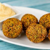 Falafel · Fried crispy balls of ground chickpea, garlic, and herbs, served with hummus and tahini.