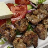 Pork Souvlaki · Marinated and grilled on a skewer, served with tzatziki and house salad.