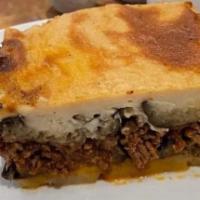 Moussaka · Thinly sliced layers of eggplant, potatoes, and seasoned local ground beef topped with becha...