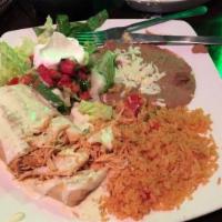 Señor Iguanas · Choice of shredded chicken or ground beef. Topped with red sauce, cheese, lettuce, sour crea...