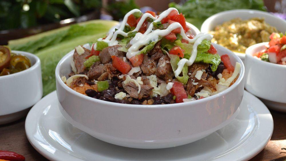 Naked Burrito Bowl · Choose from: shredded chicken, pork carnitas, spicy steak, vegetarian, ground beef, barbacoa or green chile chicken. Filled with: rice, your choice of refried or black beans, lettuce, sour cream, pico de gallo and shredded cheese.