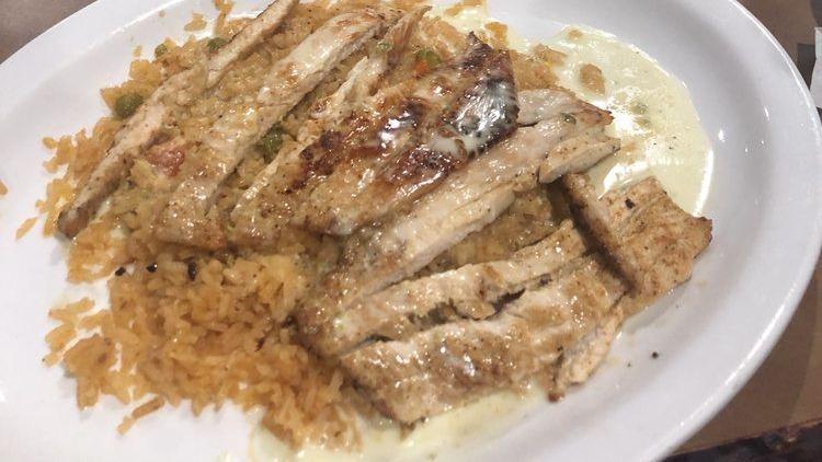 Arroz Con Pollo · Marinated grilled chicken breast and vegetables served over rice.