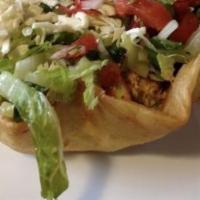 Classic Taco Salad · Your choice of shredded chicken or ground beef served in crisp tortilla shell. Topped with s...