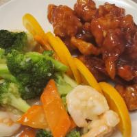Dragon Meets Phoenix · Half is sautéed shrimp with vegetables in white sauce and general tso's chicken in the other...