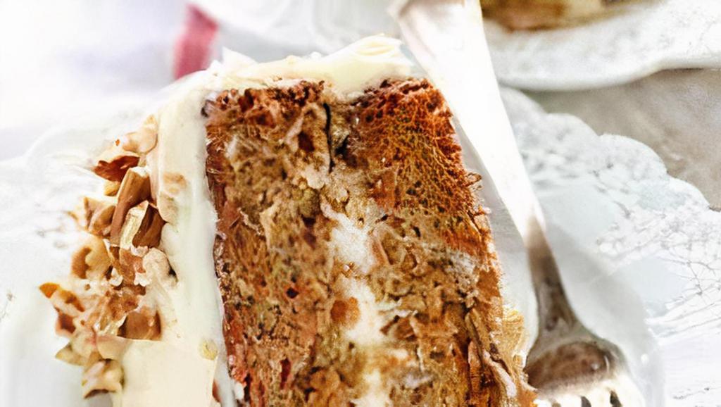 Carrot Cake · A moist ＆ balanced carrot cake covered with a silky cream cheese frosting topped with walnuts prepared by Table De Delice