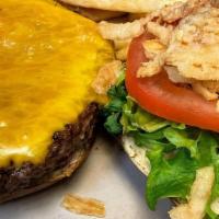 8 Oz Bay-Sized Burger · Our steak burger patty with lettuce, tomato, and crispy onions topped with cheese on a brioc...