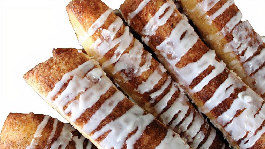 Cinnamon Sugar Breadsticks · Our signature dough covered in cinnamon and sugar baked to perfection and drizzled with
icing. Served with a side of icing for dunking.