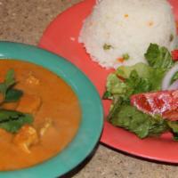Chicken Tikka Masala (Gf) · Chicken cooked in a tomato-based cream sauce served with basmati rice & salad.
