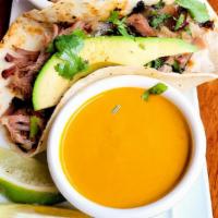 A La Carte Taco · One taco with either brisket, or pork, topped with an avocado slice, pico de gallo, and our ...