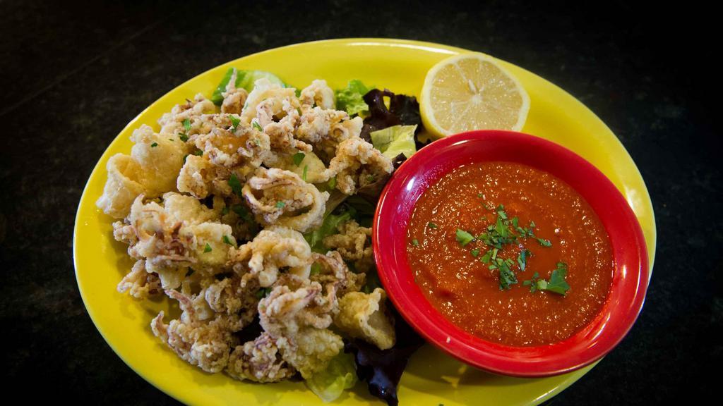 Calamari Fritti · Lightly dusted and deep-fried to a golden brown. Served with lemon and a side of sauce.