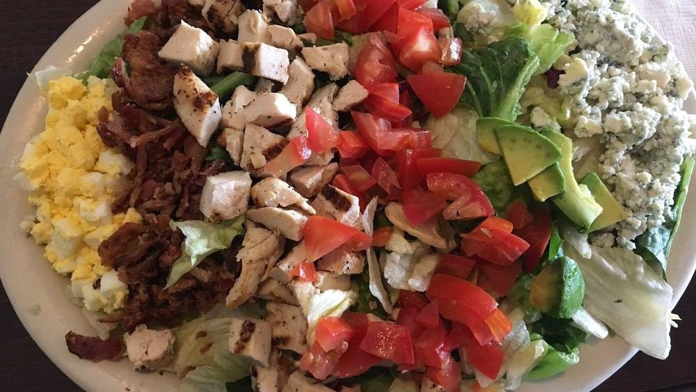 Cobb Salad · Fresh lettuce with crispy bacon, tomatoes, avocado, hard boiled egg, blue cheese, and grilled chicken, served with zinfandel vinaigrette.