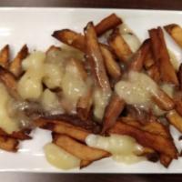 Poutine · House fries topped with Wisconsin cheddar curds topped with a country pepper gravy.
