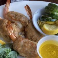 Baked Stuffed Shrimp · Four jumbo shrimp stuffed with a savory crab stuffing served with drawn butter, and your cho...