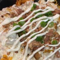 Loaded Waffle Fry Nachos · Crispy waffle fries topped with queso, shredded cheese, sour cream, green onion, and crisp b...