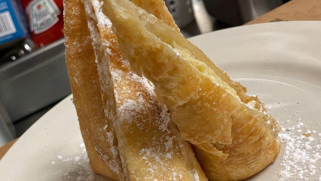 Cheesecake Chimis · Rich creamy cheesecake stuffed inside a 6-inch flour tortilla shell, deep fried and dusted with powdered sugar.  Served with your choice of sauce.