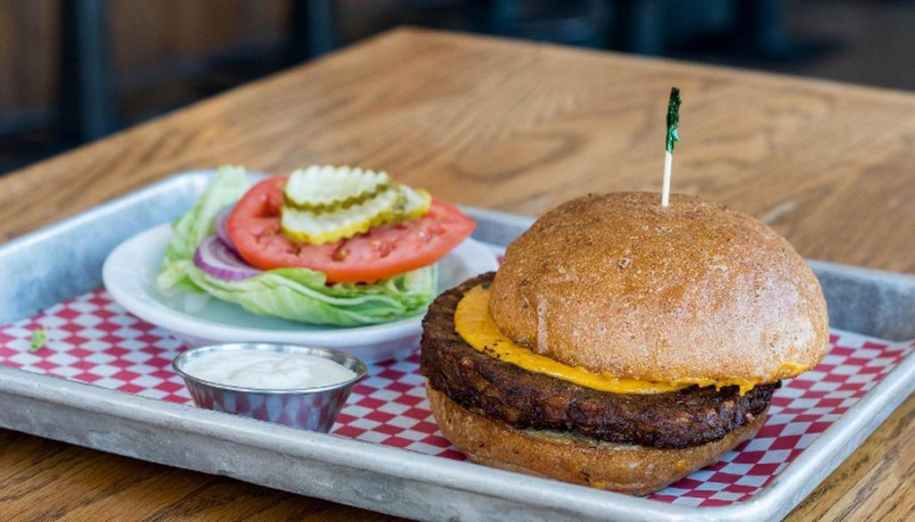 Vegan Burger · House-made farro, mushroom, zucchini, red onion, miso & flax patty. Served on a vegan bun w/ vegan cheese. Made with peanut oil. *lettuce, tomato, onion & pickles served on the side*