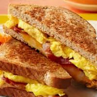 Breakfast Sandwich · Scrambled Egg, American cheese, choice of bacon, sausage.
