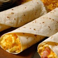 Breakfast Taco · Scrambled egg, cheddar cheese, choice of bacon, sausage wrapped in a flour tortilla.