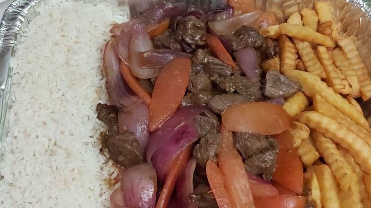 Lomo Saltado Family Tray For 2-3 People · Tender Steak, Fresh Onions, Tomatoes mixed in a fine blend of spices  made at the time you order it. Served with a family side of Rice and Fries.
