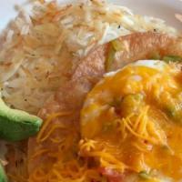 Huevos Rancheros · Eggs on fried tortilla, avocado, ranchera sauce, shredded potatoes.