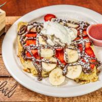 Strawberry Nutella French Toast · Topped with whipped cream and strawberry syrup.