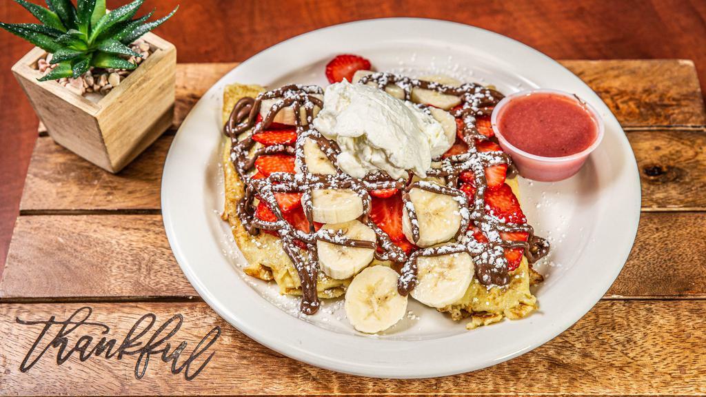 Strawberry Nutella French Toast · Topped with whipped cream and strawberry syrup.