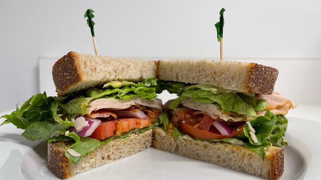 Turkey Bacon Avocado Sandwich · Smoked bacon, sliced turkey,
chipotle Mayo, lettuce, tomato served on toasted wheat bread with choice of chips or fries.