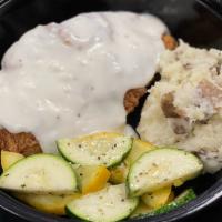 Chicken Fried Chicken · Breaded chicken topped with gravy served with seasonal vegetables and a roll.