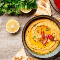 Spicy Hummus With Pita · Mashed chickpeas, spicy sauce, lemon juice, tahini sauce, special spices topped with olive o...