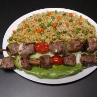 Lamb Kabob Entrée · Marinated pieces of lamb grilled to perfection, served with rice and grilled vegetables.