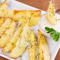 Garlic Parmesan Potatoes · Fresh baked potatoes topped with seasoned garlic and parmesan.