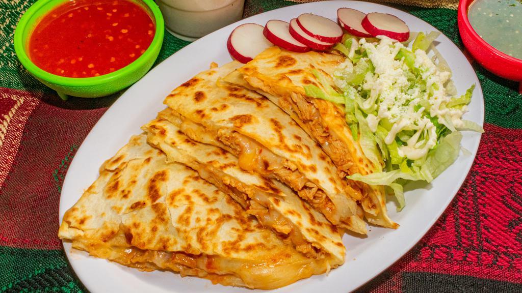 Quesadilla · Meat of your choice and Oaxaca cheese melted in a flour tortilla. On the side is lettuce, Cotija cheese and Mexican crema. Comes with 2 salsas. We offer carne asada (grilled steak),carnitas, beef barbacoa, chicken tinga, grilled chicken, two bean vegetarian, chorizo, al pastor and mixtos!