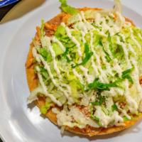2 Tostadas Combo · 2 fresh fried tostadas topped with refried beans, meat of your choice, lettuce, Mexican crem...