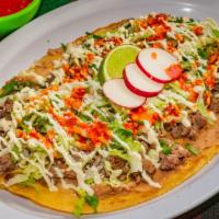 Huaraches · Handmade oval soft corn tortilla topped with refried beans, meat of your choice, cilantro, o...