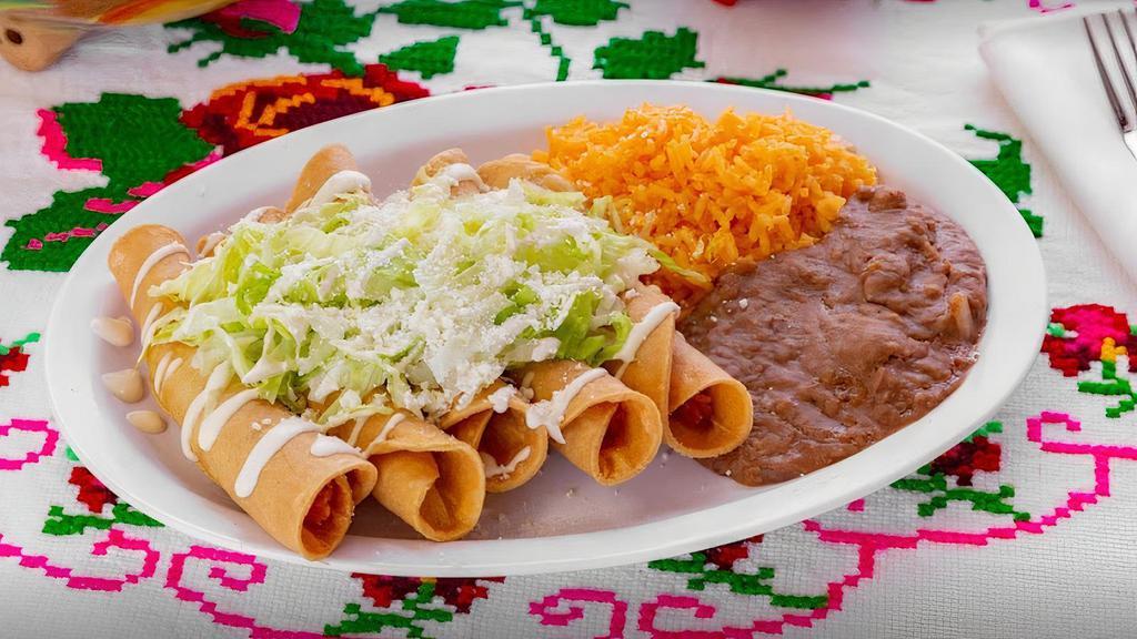 Flautas · 5 crunchy rolled chicken and mashed potato tacos topped with lettuce, Mexican crema and Cotija cheese. Rice and refried pinto beans served on the side. Comes with 2 salsas.