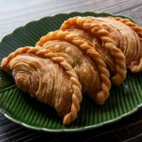Curry Puff · Curried minced chicken, potatoes and onions in a pastry puff, fried until golden brown and s...