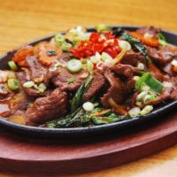 Sizzling Beef · Sautéed marinated with herbs in a light brown sauce and served on a hot sizzling plate with ...
