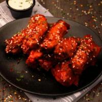 Original Buffalo Wings · Seven wings tossed in our original Buffalo sauce and sesame seeds. Served with your choice o...