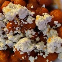Buffalo Cauliflower · Cauliflower florets are tossed in buffalo sauce covered with blu cheese crumbles topped with...