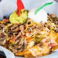 Carne Asada Fries · Carne Asada with fries, topped with melted cheese, sour cream, pico de gallo, guacamole and ...