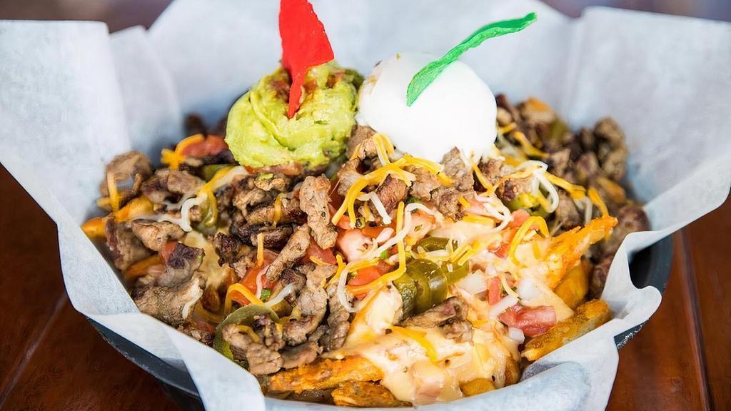 Carne Asada Fries · Carne Asada with fries, topped with melted cheese, sour cream, pico de gallo, guacamole and jalapeño